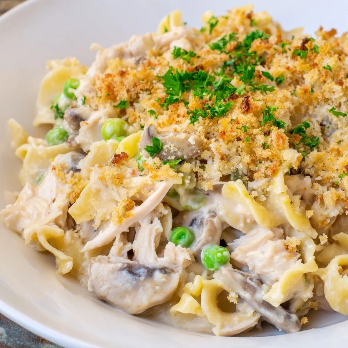 Golden-brown Tuna Noodle Casserole bubbling hot, topped with crispy panko and Parmesan.