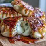 Melted mozzarella cheese oozes from a soft potato mochi, garnished with scallions for a savory Japanese snack.