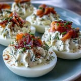 Creamy deviled eggs with smoked salmon and chives, finished with everything seasoning for a flavorful bite.  