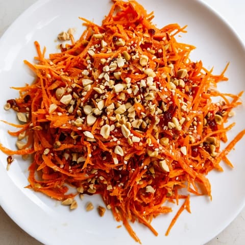Close-up of a refreshing Spicy Carrot Salad; the crunchy, colorful salad has a zesty Asian dressing.