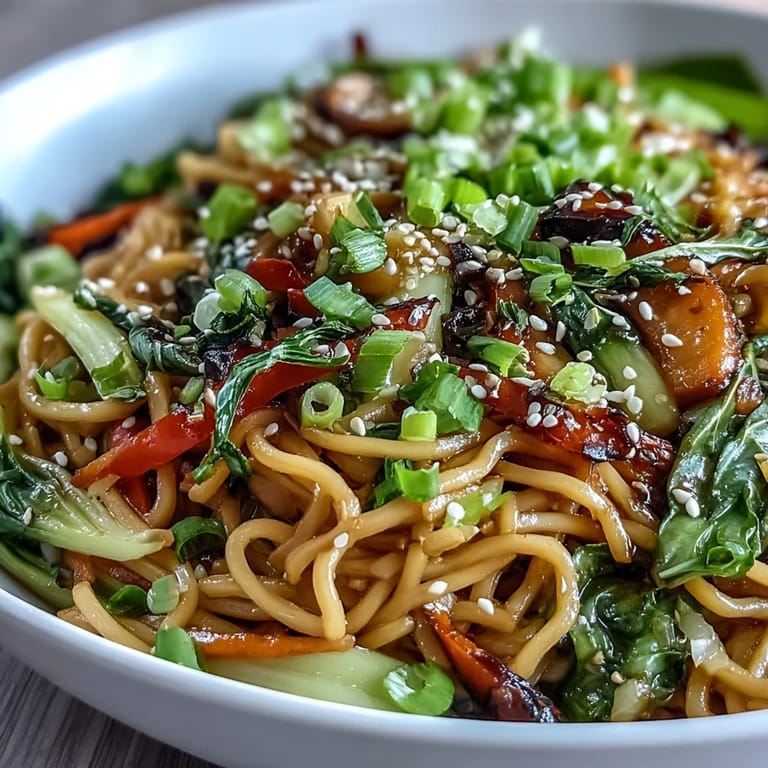 Shirataki Noodle Bowl garnished with toasted sesame seeds and fresh cilantro, served with chopsticks on a wooden table.