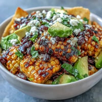 Vibrant grilled corn and black bean taco salad loaded with colorful veggies and zesty lime dressing.