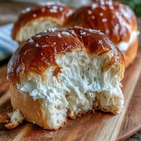 Golden brown Japanese Milk Bread loaf, sliced to reveal its incredibly soft, pillowy interior.