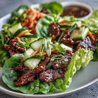 Korean BBQ beef lettuce wraps with spicy kimchi, a vibrant, low-carb meal.